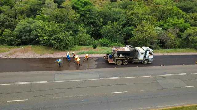 Drone view: crew surfacing a road lane