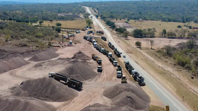 Drone view: trucks loading at material stockpiles